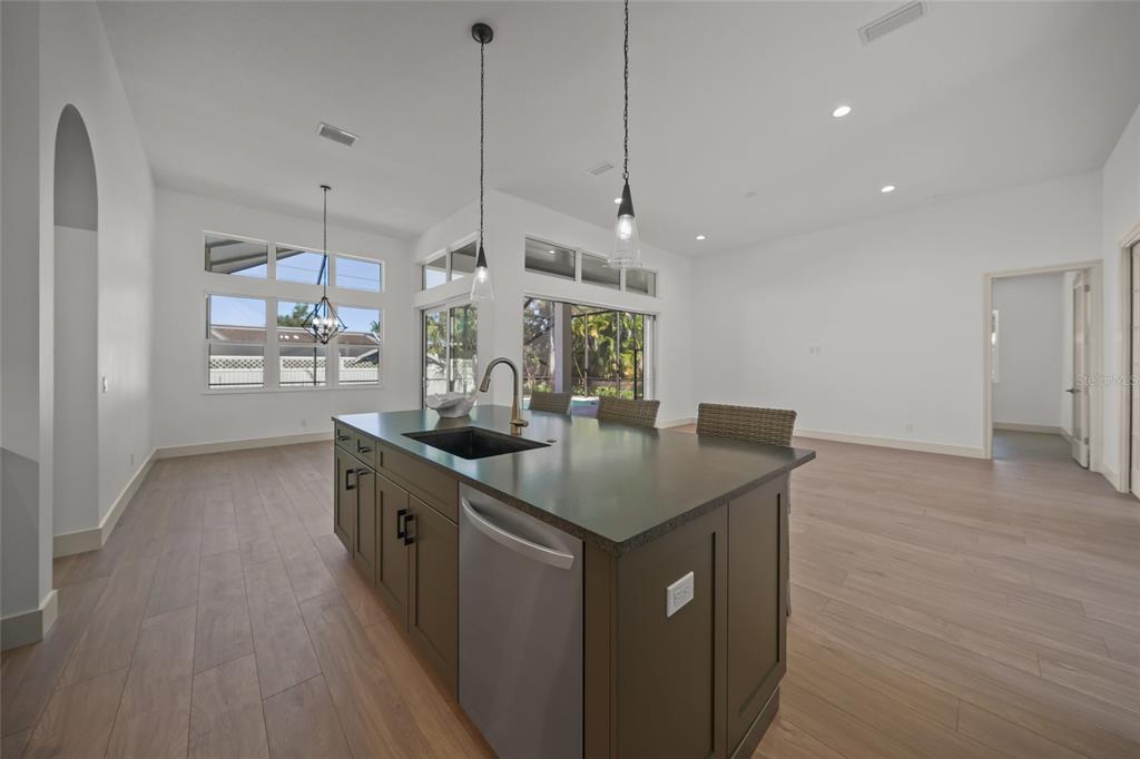 504 Gulf Street Venice, FL 34285 - Photo 11 of 47 a kitchen with stainless steel appliances granite countertop a sink a counter space and wooden floor
