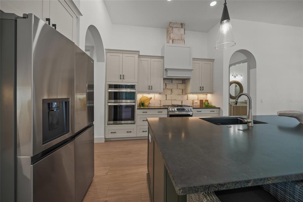 504 Gulf Street Venice, FL 34285 - Photo 12 of 47 a kitchen with kitchen island a counter top space cabinets and stainless steel appliances