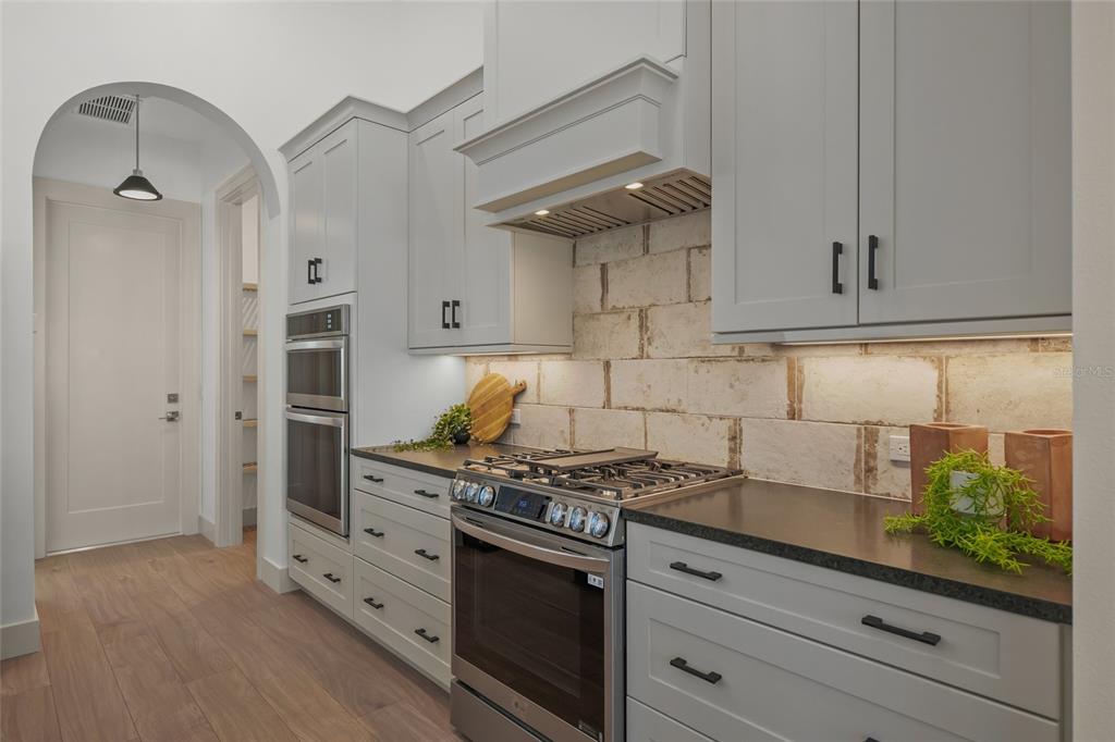 504 Gulf Street Venice, FL 34285 - Photo 13 of 47 a kitchen with stainless steel appliances white cabinets and a stove