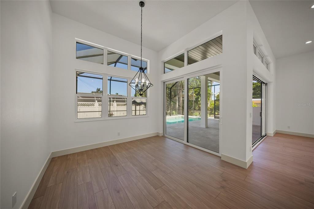 504 Gulf Street Venice, FL 34285 - Photo 15 of 47 a view of an empty room with wooden floor and a window