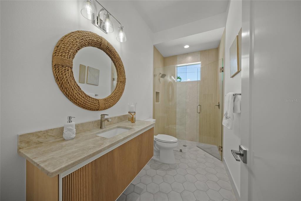 504 Gulf Street Venice, FL 34285 - Photo 24 of 47 a bathroom with a granite countertop sink a mirror and a toilet