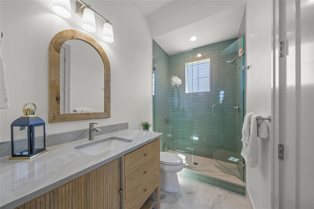 504 Gulf Street Venice, FL 34285 - Photo 33 of 47 a bathroom with a double vanity sink toilet and shower