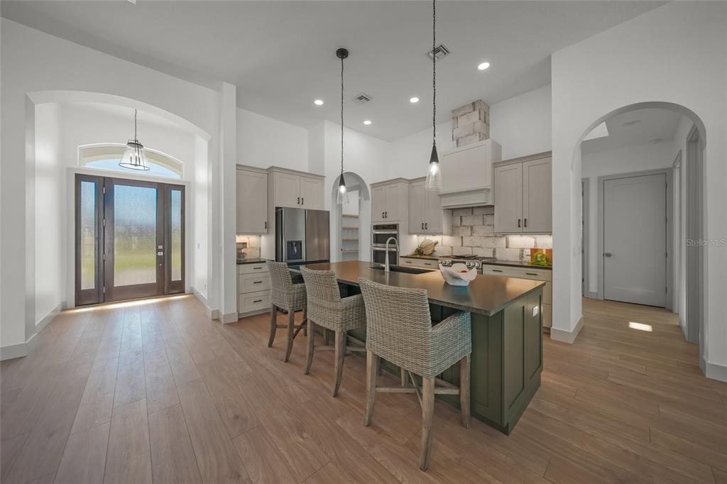 504 Gulf Street Venice, FL 34285 - Photo 9 of 47 a kitchen with stainless steel appliances kitchen island granite countertop a table chairs refrigerator sink and cabinets