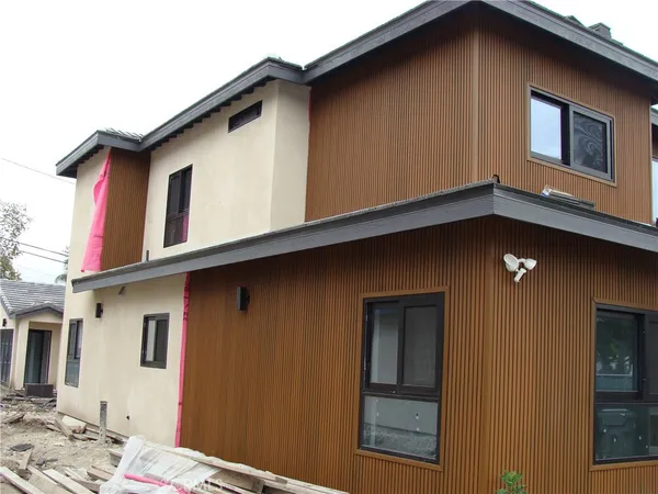 a view of a house with wooden fence