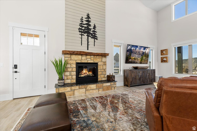 1210 East Bristle Cone Road Pine Valley, UT 84781 - Photo 7 of 54 Living area featuring a fireplace, a high ceiling, and light wood-like tile finished floors