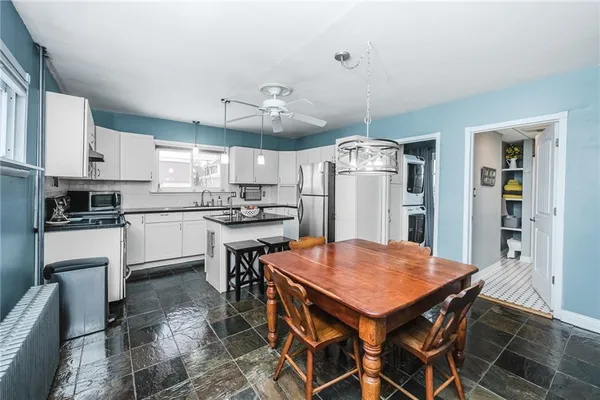 a kitchen with a sink a refrigerator a stove a microwave and cabinets