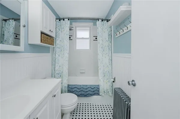 a bathroom with a toilet a sink and mirror