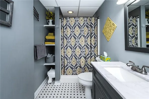 a bathroom with a sink toilet and shower