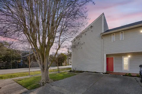 a view of a house with a yard and tree s