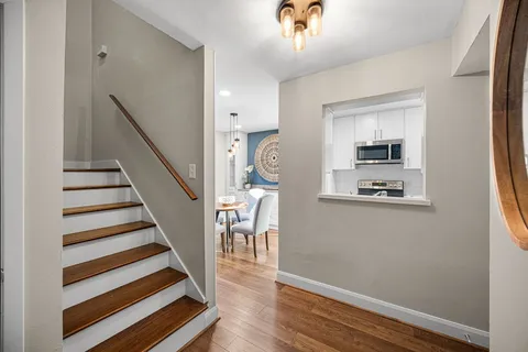 a view of entryway and hall with wooden floor