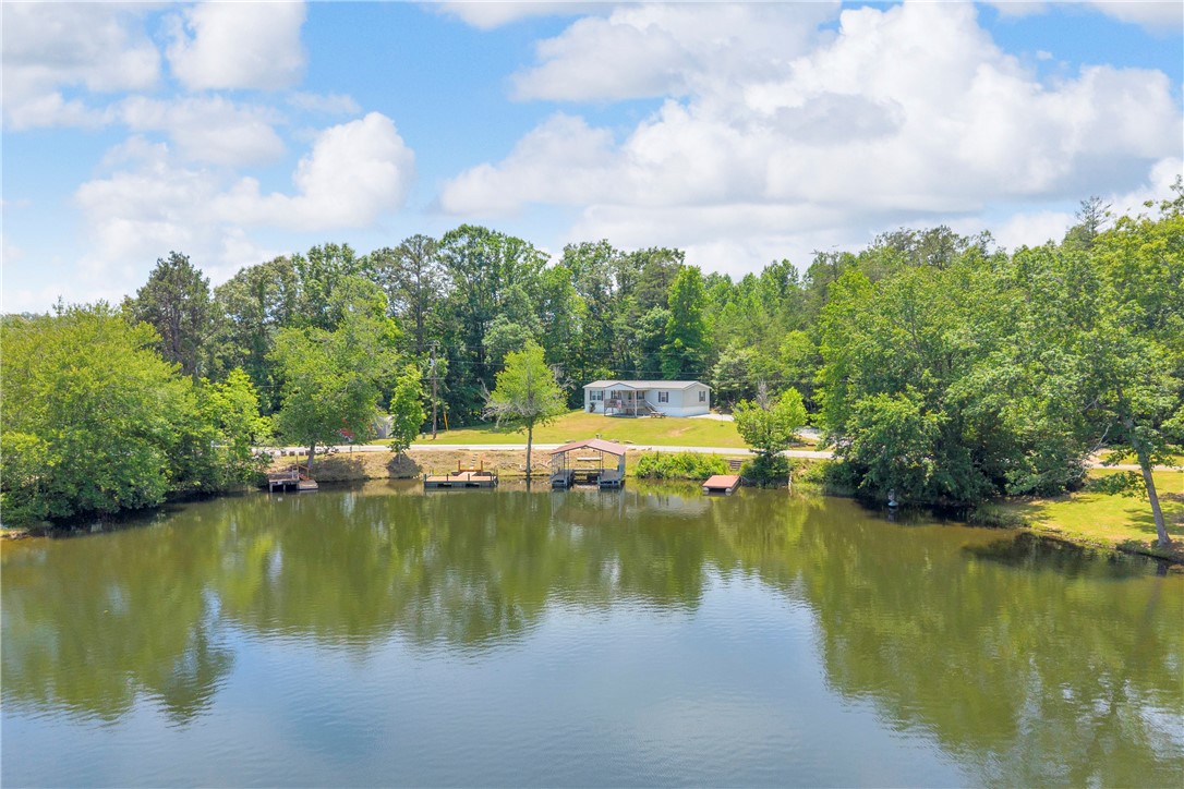 334 Lake Becky Road Mountain Rest, SC 29664 - Photo 33 of 46 A tranquil lakefront property featuring a private boat dock and wooded surroundings.