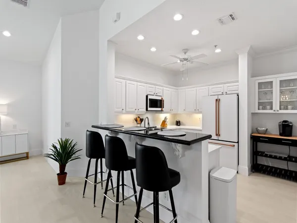 a kitchen with stainless steel appliances a sink and a refrigerator