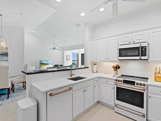 a kitchen with a sink a microwave and cabinets