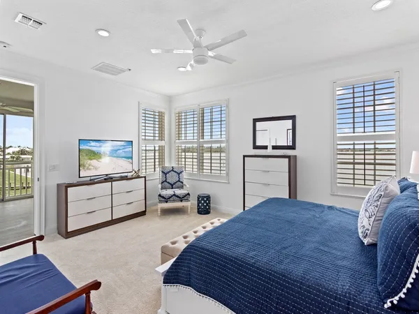 a bedroom with a bed a couch and dresser