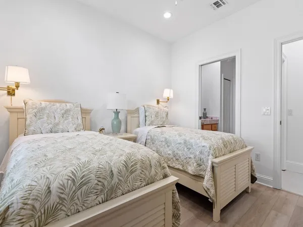 a bedroom with two beds and lamp