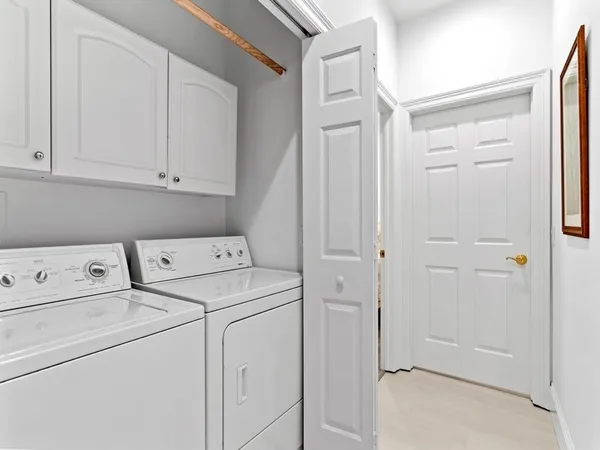 a view of storage and utility room with washer and dryer