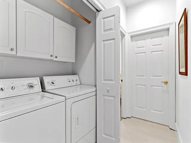 a view of storage and utility room with washer and dryer
