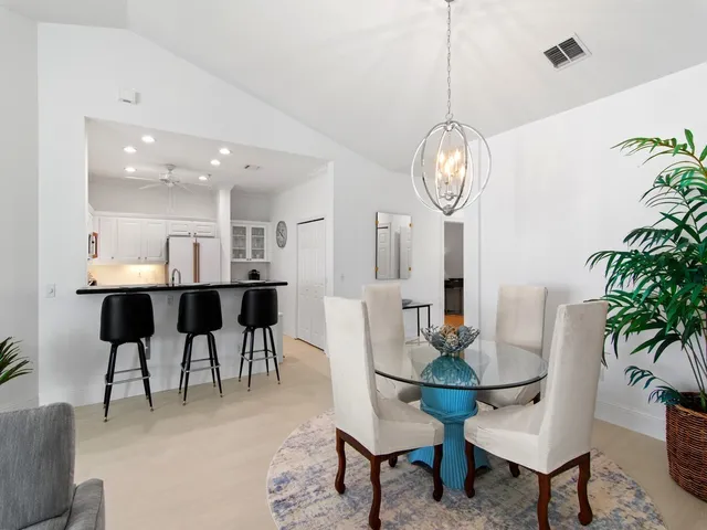 a view of a dining room with furniture and a chandelier