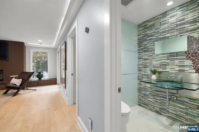 a spacious bathroom with a toilet a sink and mirror