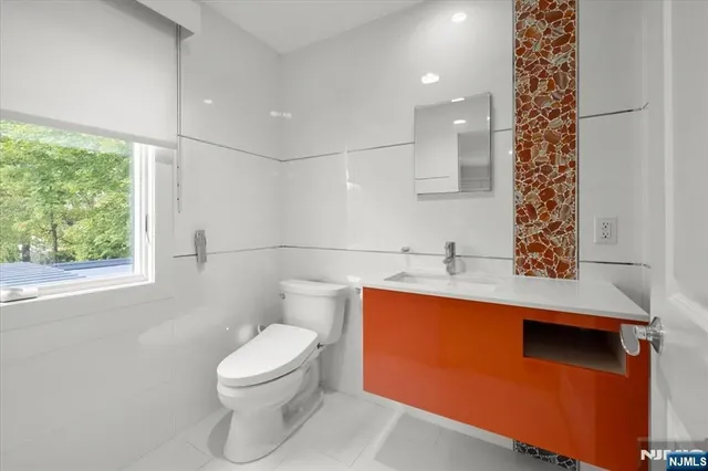 a bathroom with a toilet a sink and a window