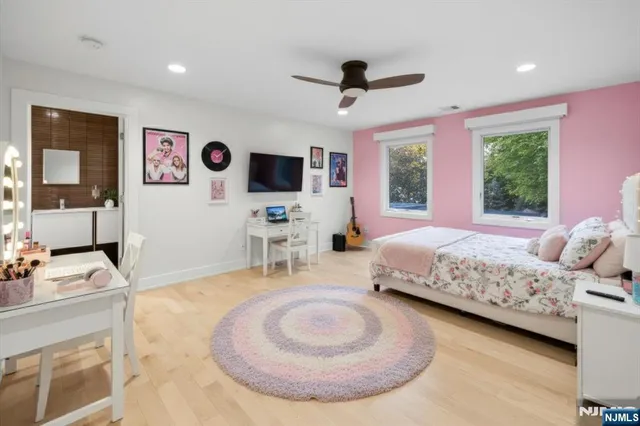 a bedroom with a large bed and a flat screen tv