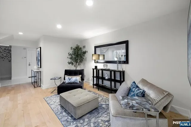 a living room with furniture and a painting on the wall
