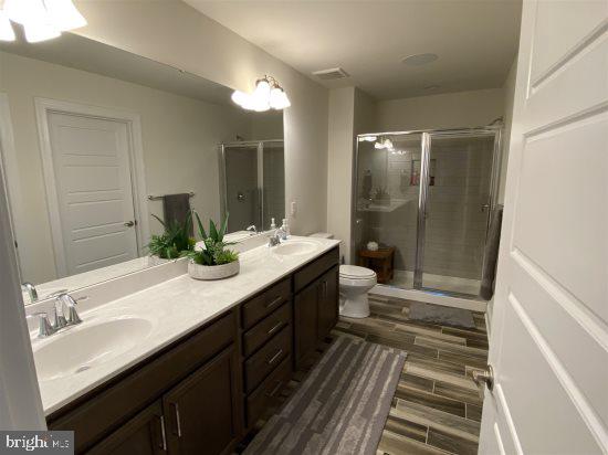 19209 Cavendish Way Lewes, DE 19958 - Photo 6 of 6 a bathroom with a double vanity sink and mirror