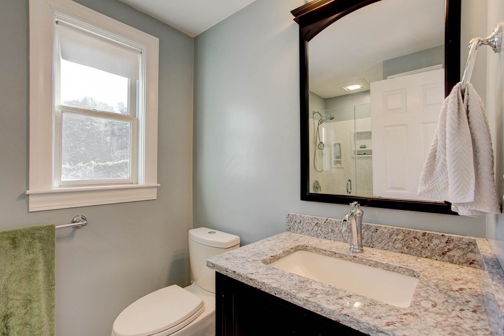 51 Green Road Bolton, MA 01740 - Photo 11 of 25 a bathroom with a granite countertop sink toilet and mirror