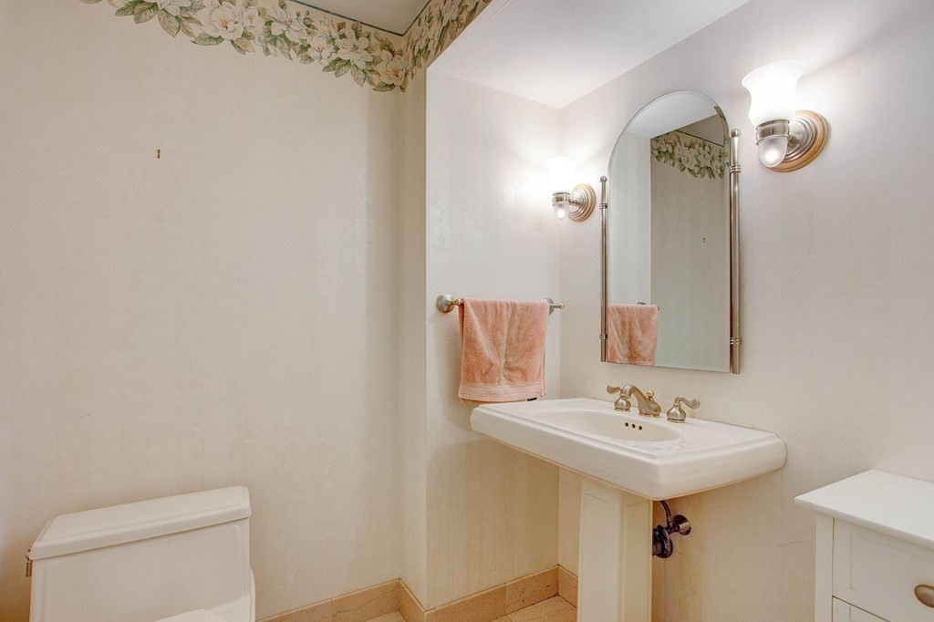 51 Green Road Bolton, MA 01740 - Photo 12 of 25 a bathroom with a sink a toilet and shower curtain
