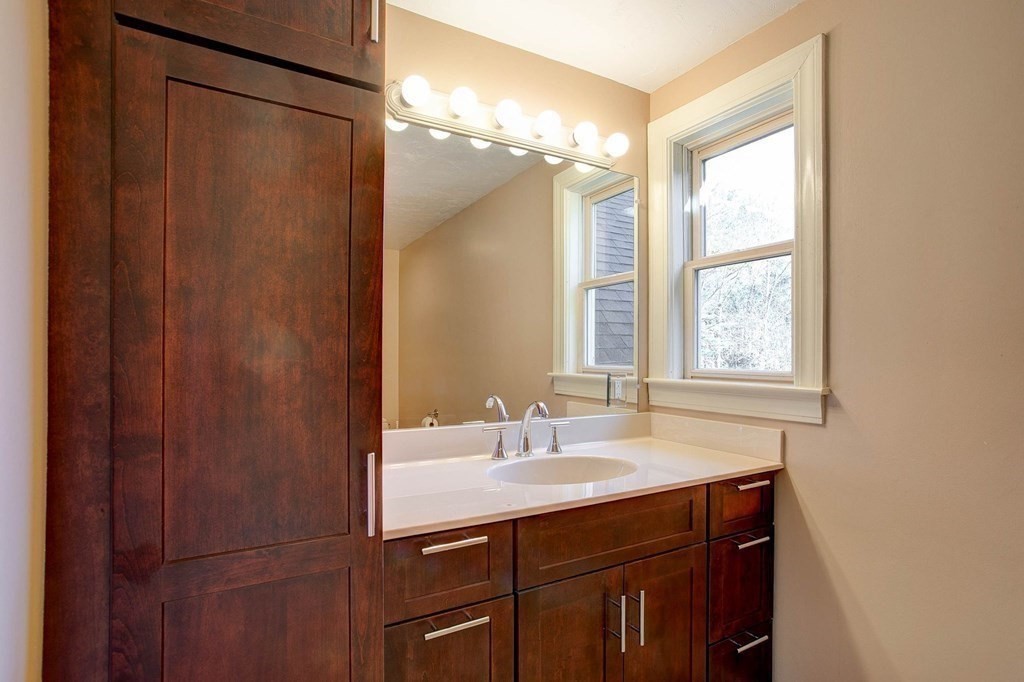 51 Green Road Bolton, MA 01740 - Photo 14 of 25 a bathroom with a double vanity sink and a mirror