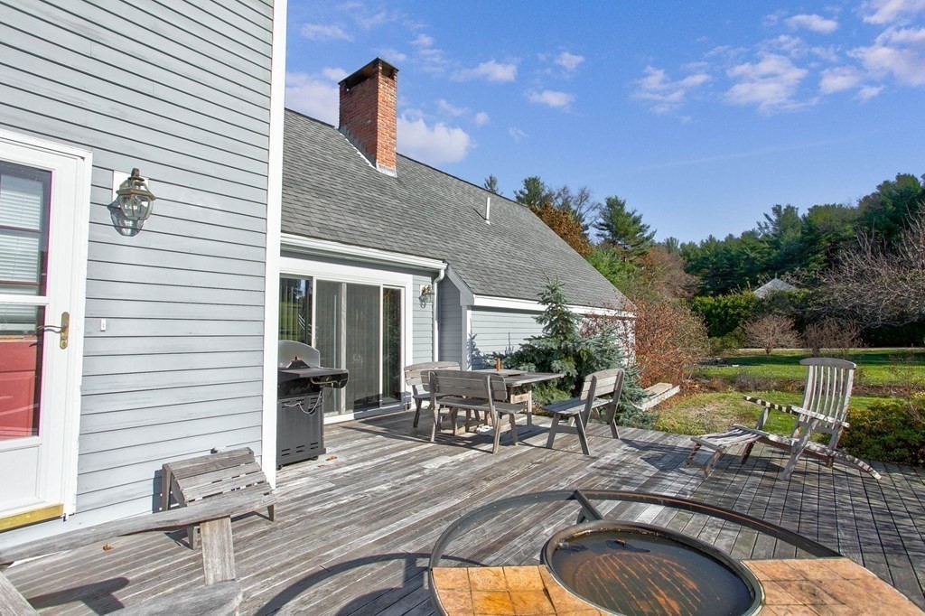 51 Green Road Bolton, MA 01740 - Photo 16 of 25 a view of a house with backyard and sitting area