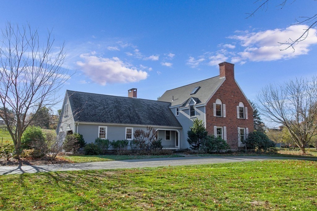 51 Green Road Bolton, MA 01740 - Photo 17 of 25 a front view of house with yard and trees in the background