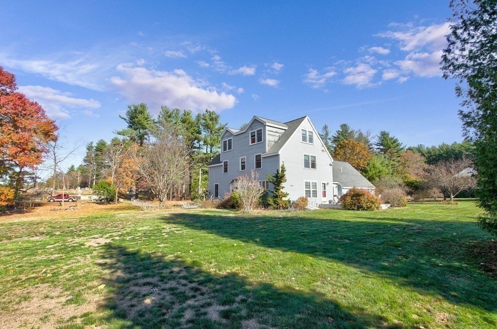 51 Green Road Bolton, MA 01740 - Photo 20 of 25 a front view of a house with garden and trees