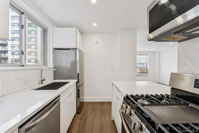 a kitchen with a stove a sink and a refrigerator