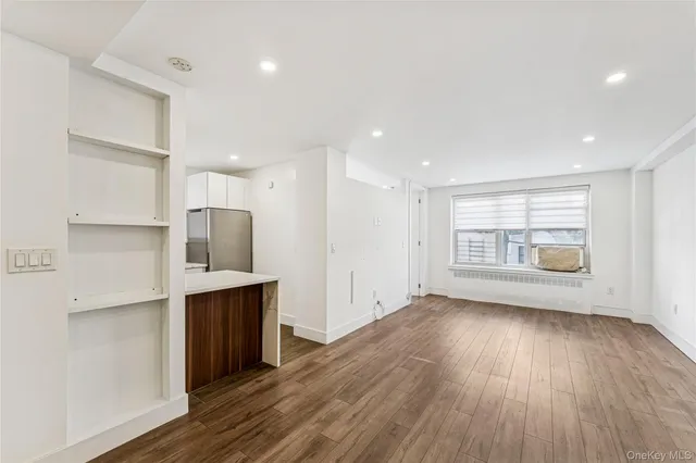 a view of kitchen with a sink refrigerator and window