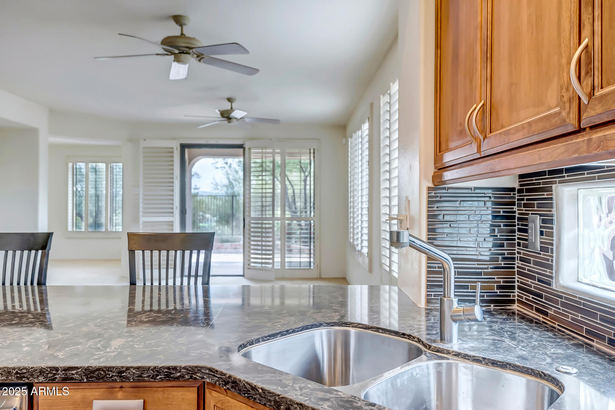41628 North Cedar Chase Road Anthem, AZ 85086 - Photo 12 of 36 a kitchen with a sink a counter top space and stainless steel appliances