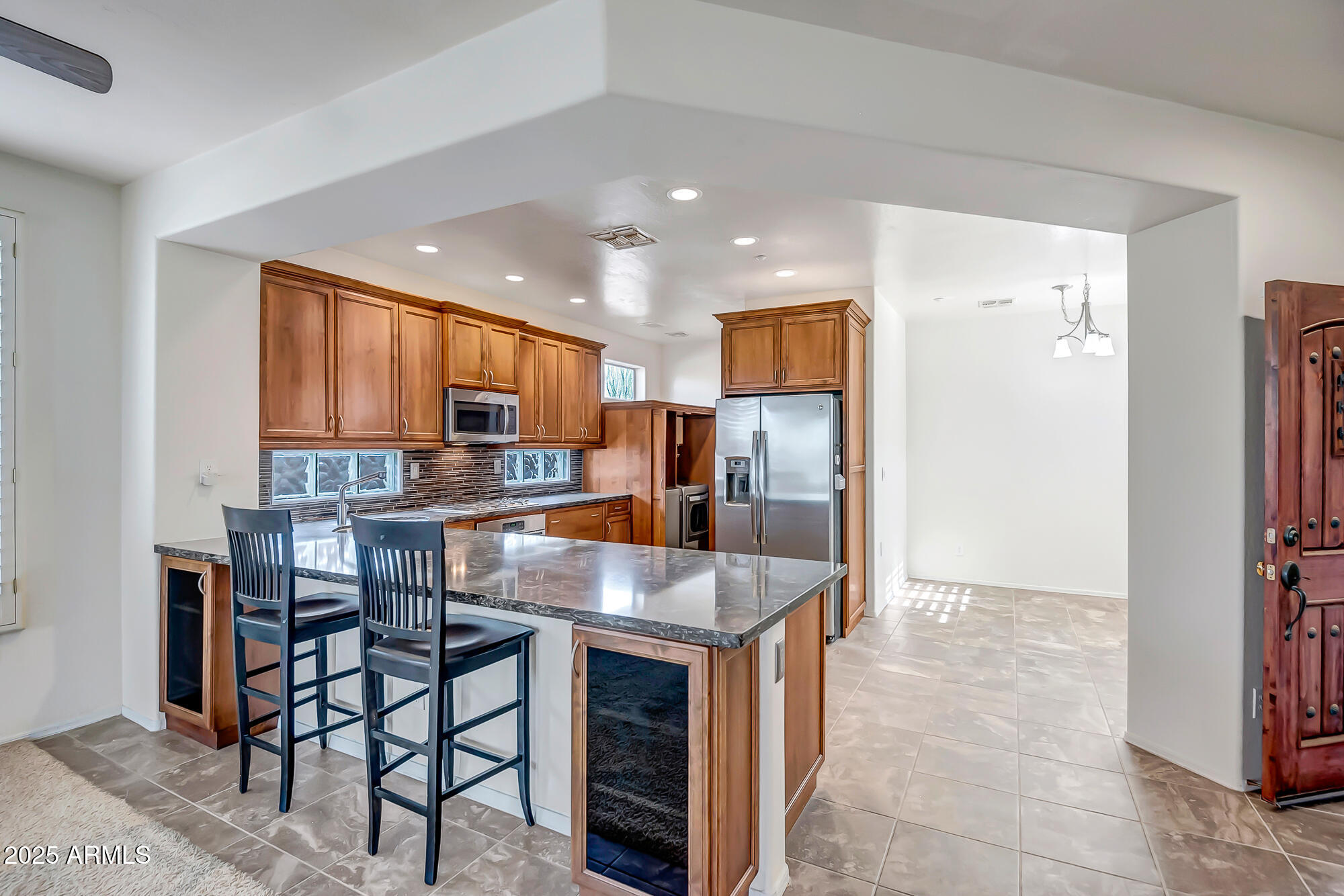41628 North Cedar Chase Road Anthem, AZ 85086 - Photo 14 of 36 a kitchen with stainless steel appliances granite countertop a refrigerator and a stove top oven