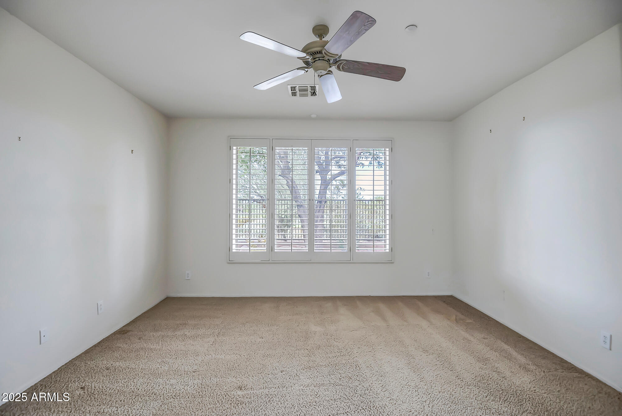 41628 North Cedar Chase Road Anthem, AZ 85086 - Photo 28 of 36 an empty room with a window and a ceiling fan