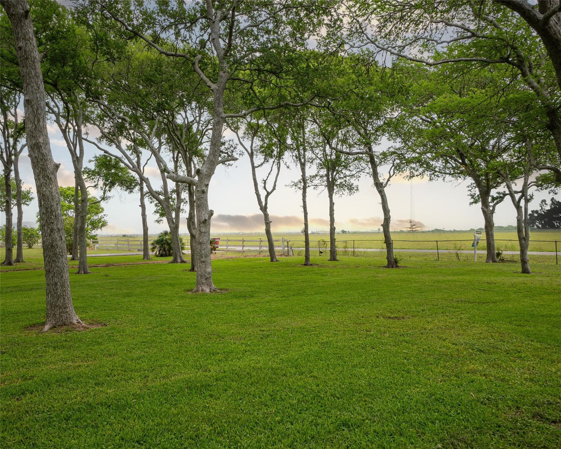 357 County Road 296 Sargent, TX 77414 - Photo 2 of 22 a view of grassy field with benches