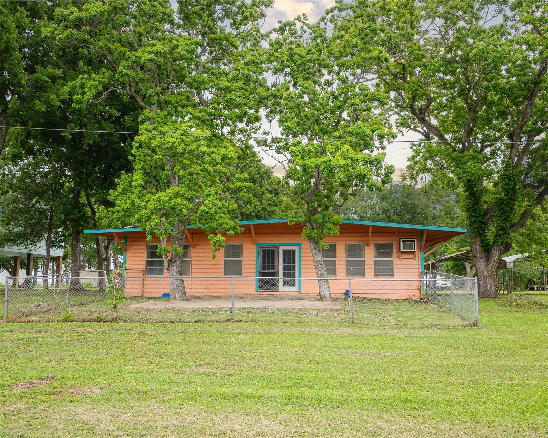 357 County Road 296 Sargent, TX 77414 - Photo 21 of 22 a backyard of a house with table and chairs