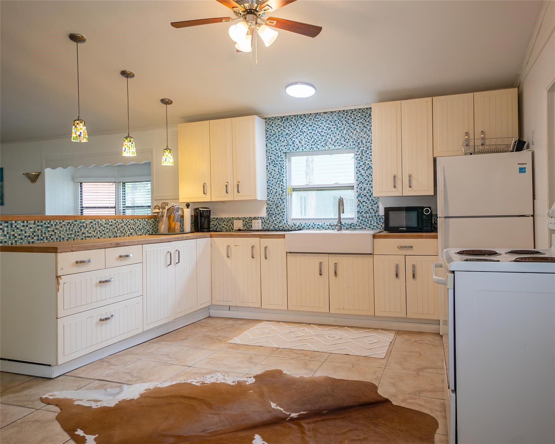 357 County Road 296 Sargent, TX 77414 - Photo 5 of 22 a kitchen with white cabinets and white appliances
