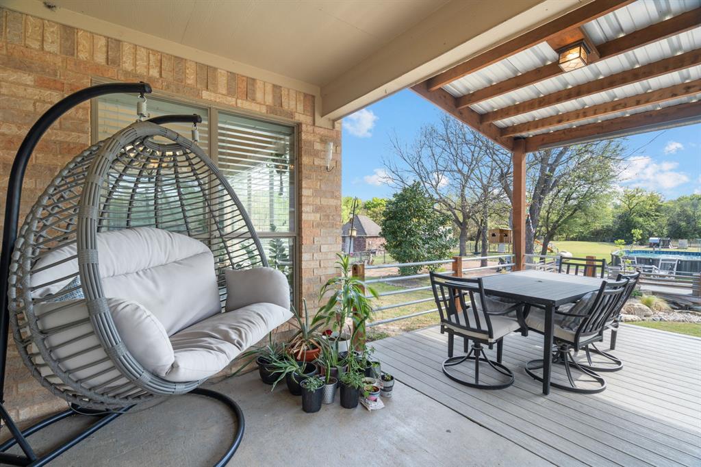 112 Waterfall Court Azle, TX 76020 - Photo 28 of 40 a balcony with table and chairs