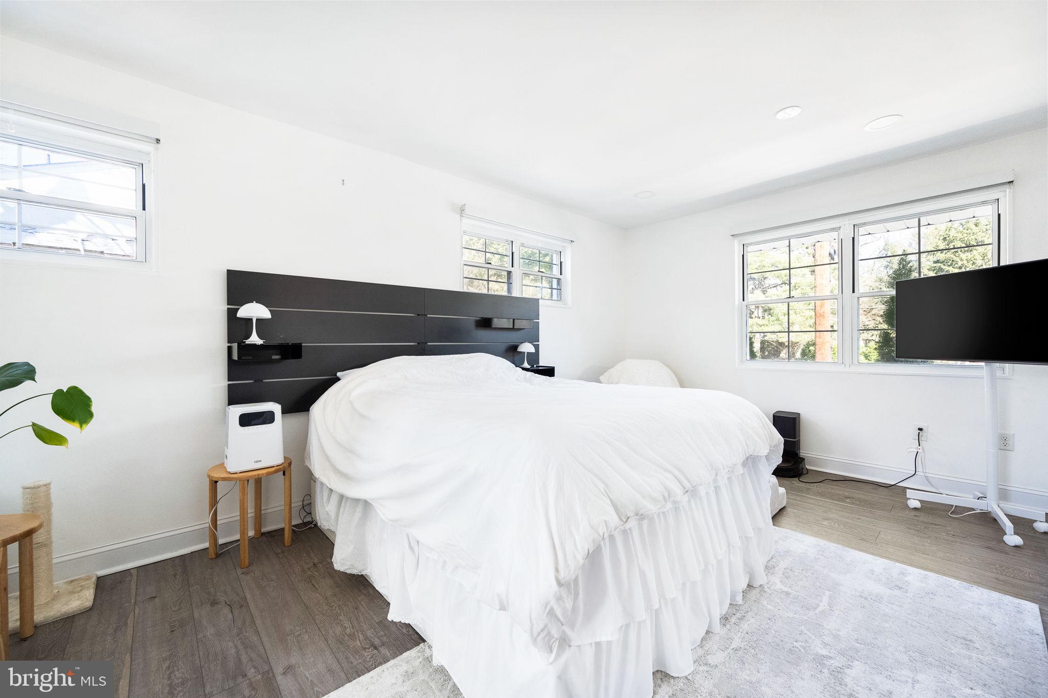 5020 River Road Bethesda, MD 20816 - Photo 12 of 35 a bedroom with a bed and flat tv screen on the dresser