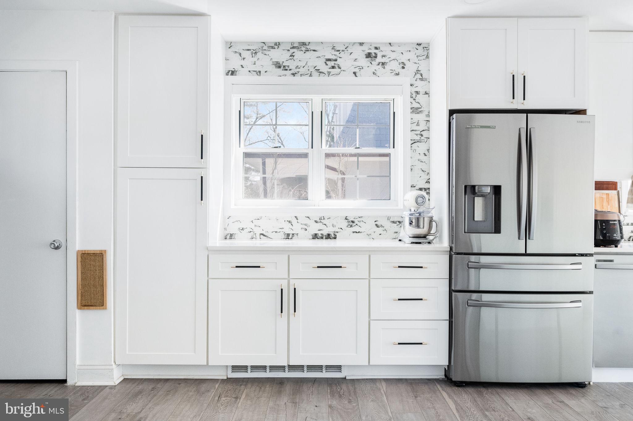 5020 River Road Bethesda, MD 20816 - Photo 16 of 35 a kitchen with granite countertop white cabinets and white appliances