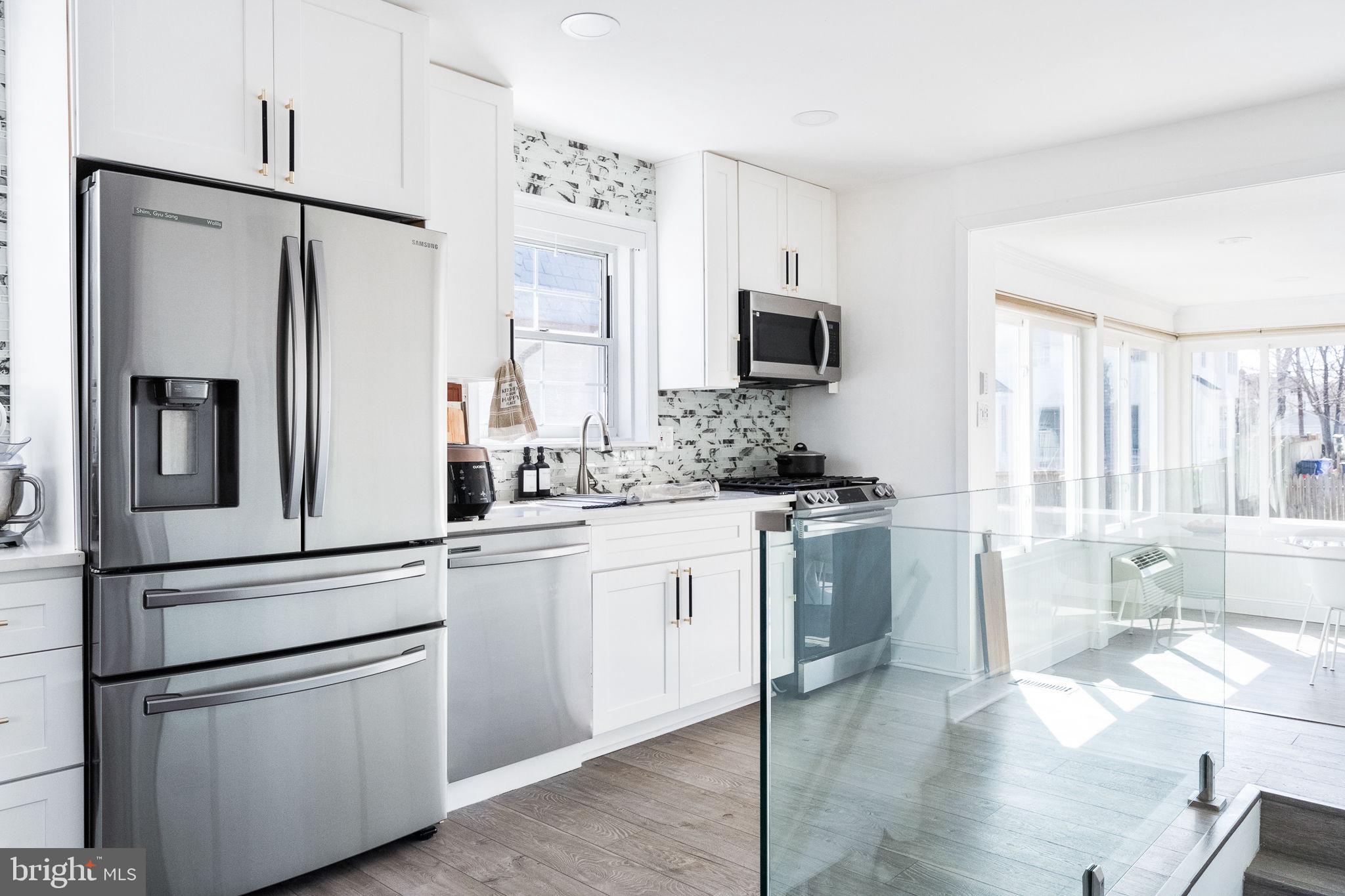 5020 River Road Bethesda, MD 20816 - Photo 17 of 35 a kitchen with stainless steel appliances white cabinets and a refrigerator