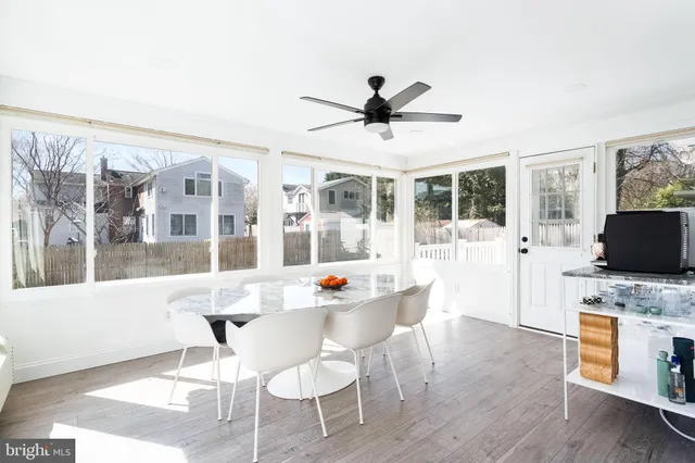 a dining room with wooden floor and a chandelier