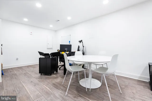 a view of a table and chairs in wooden floor
