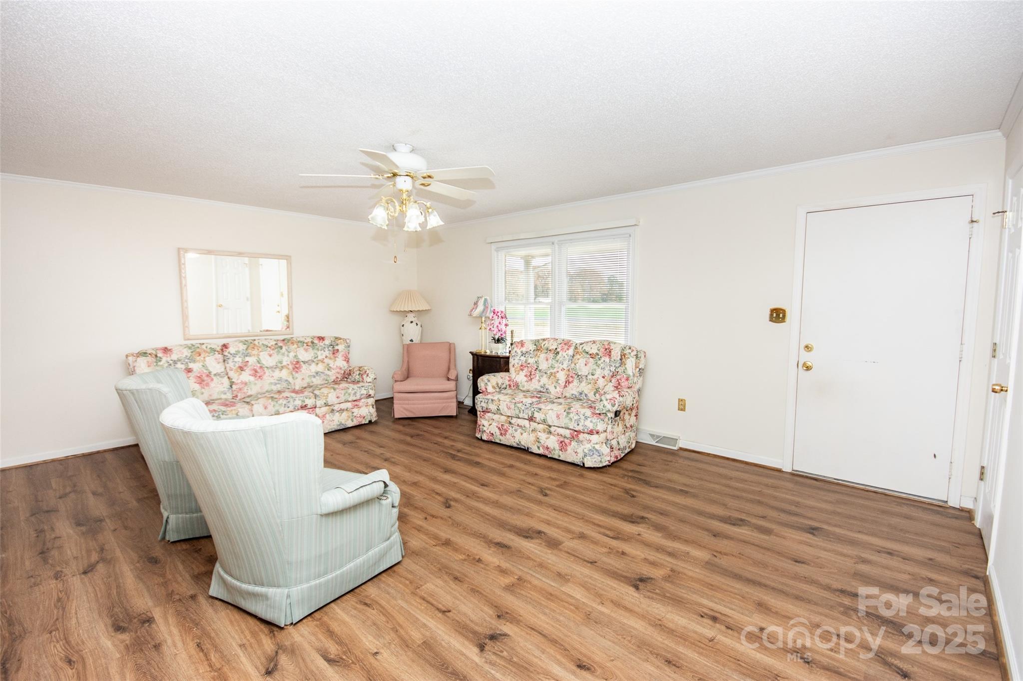 2890 Hobson Road Cleveland, NC 27013 - Photo 11 of 48 a living room with furniture and a chandelier