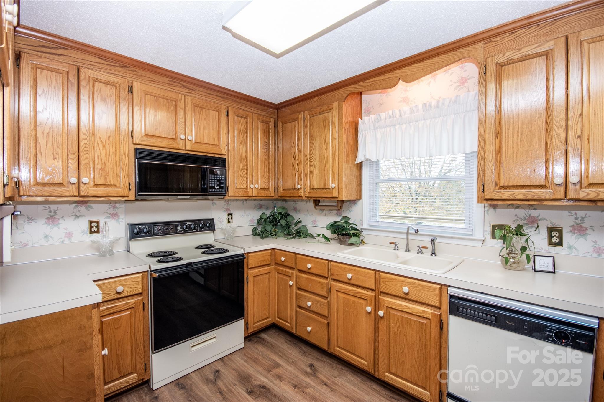 2890 Hobson Road Cleveland, NC 27013 - Photo 14 of 48 a kitchen with stainless steel appliances granite countertop a sink a stove and cabinets