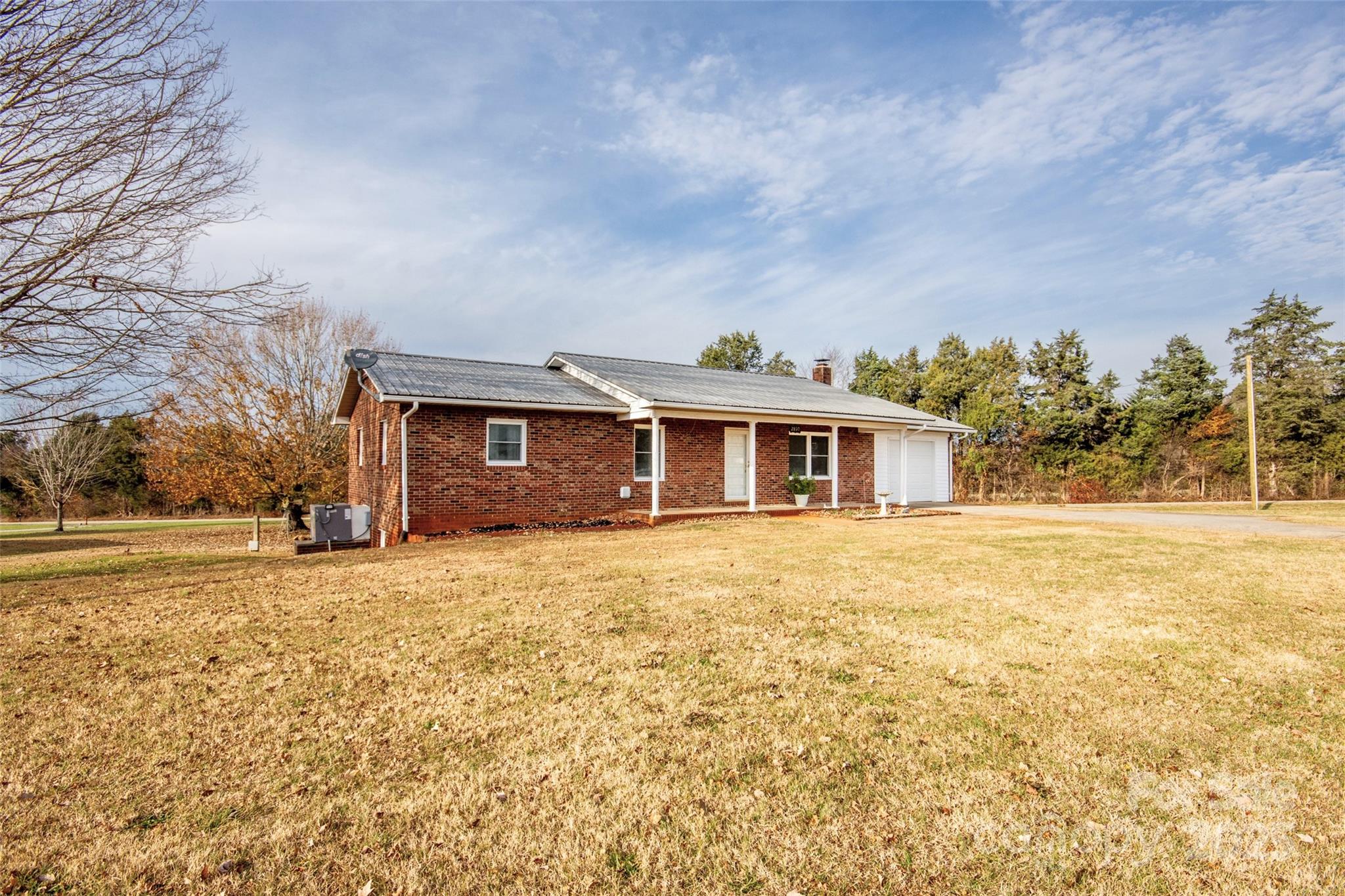 2890 Hobson Road Cleveland, NC 27013 - Photo 2 of 48 a front view of a house with a yard and garage